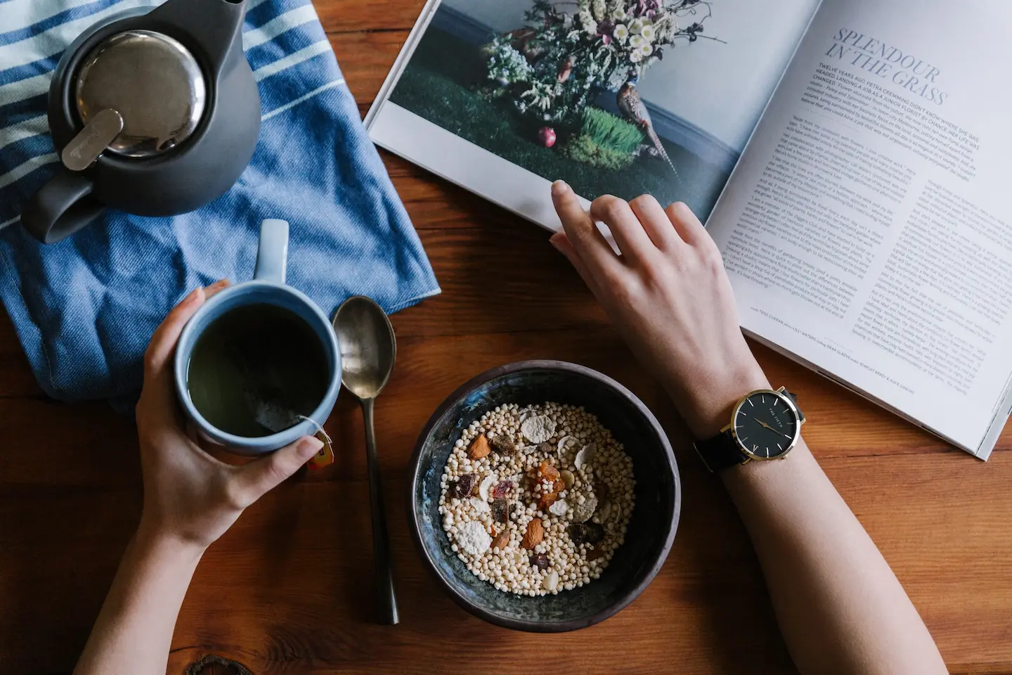 Desk with journal, coffee and watch. Someone establishing a routine.