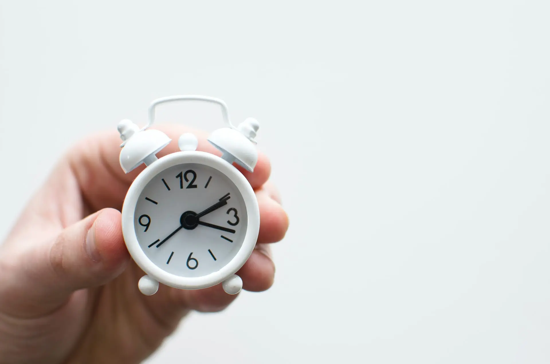 Hand holding a clock