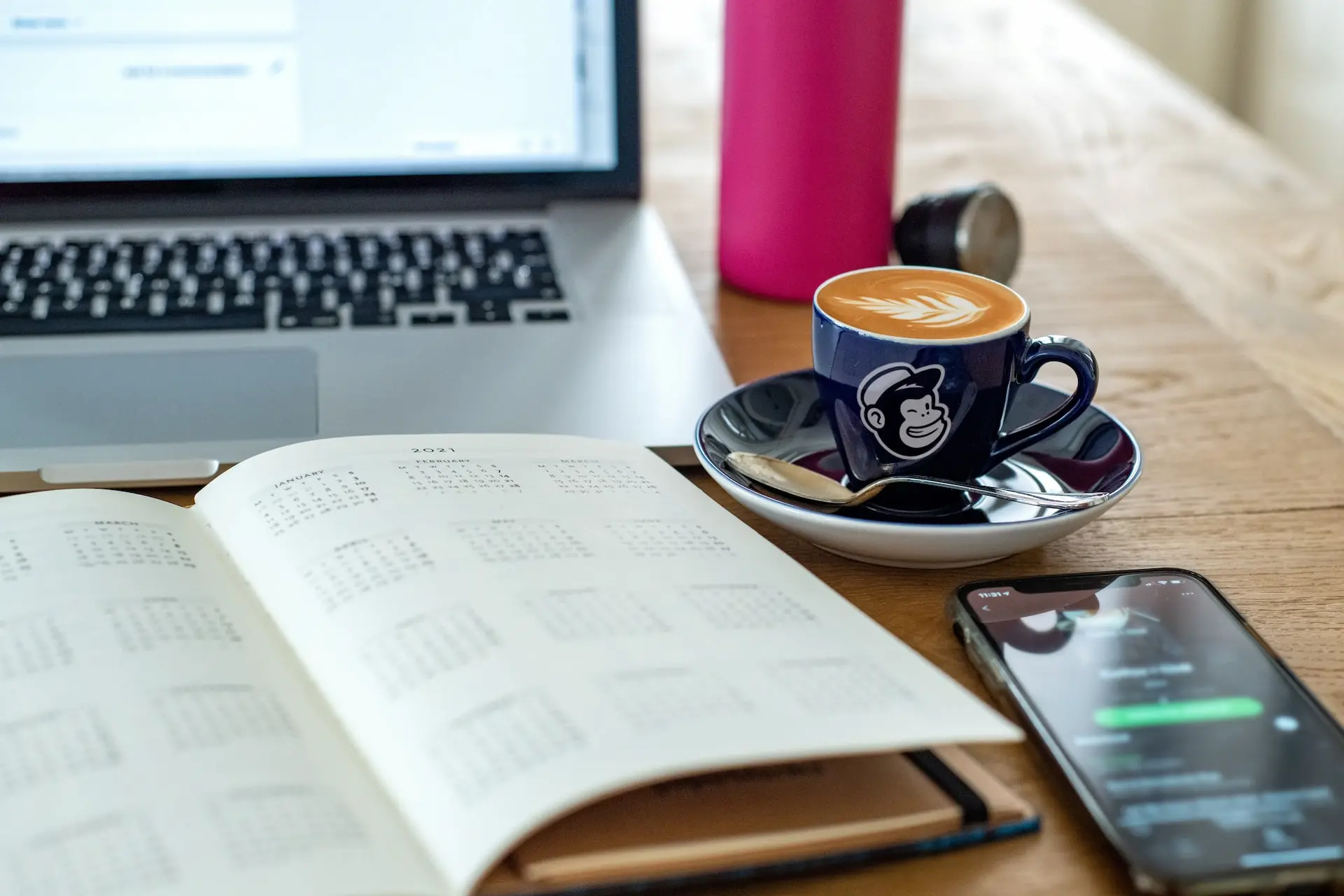 Desk with journal and a coffee