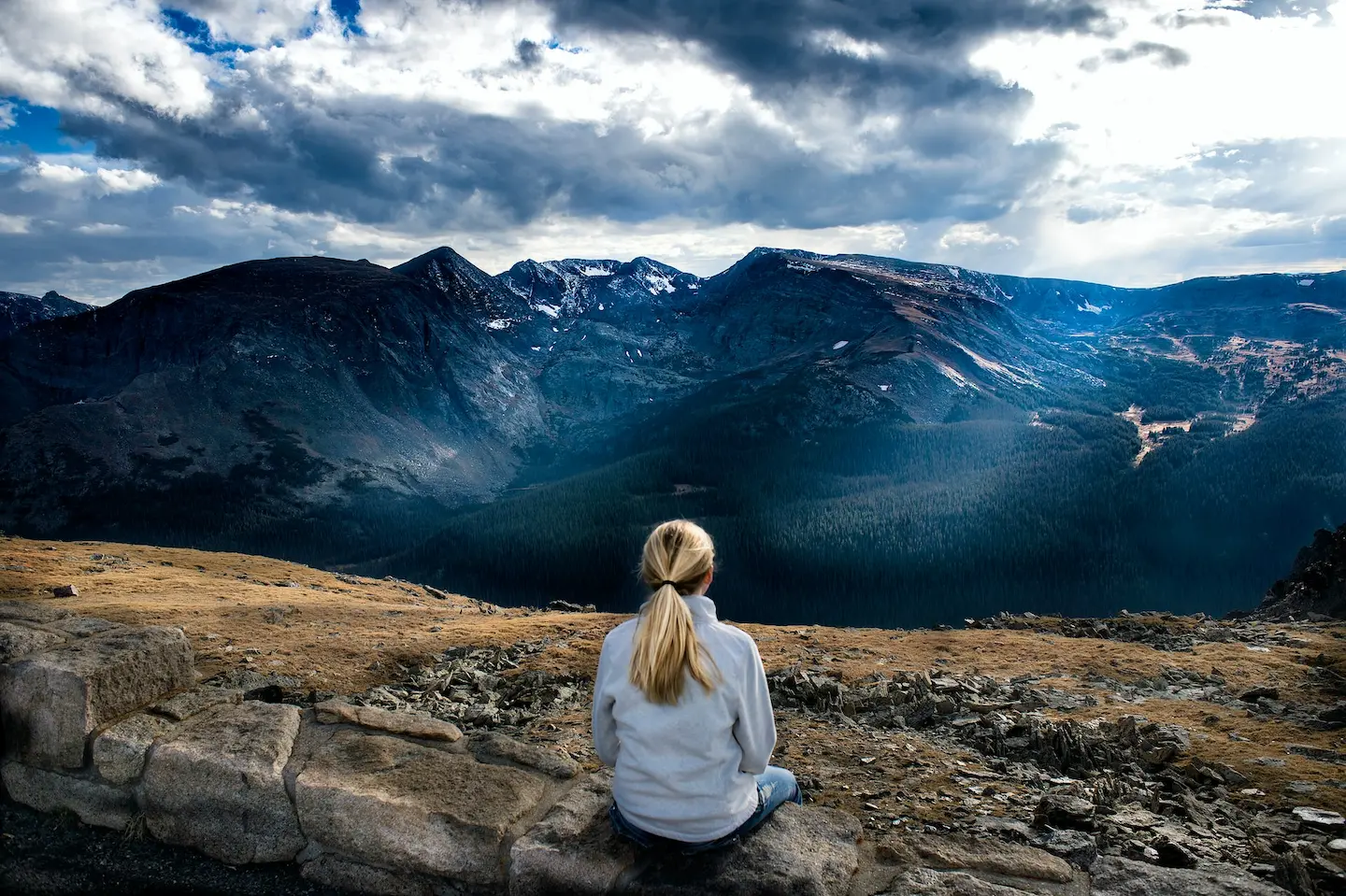 Someone relaxing and looking over the mountain